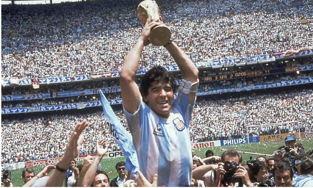 Diego Maradona holding the FIFA World Cup trophy after Argentina’s victory in 1986.
