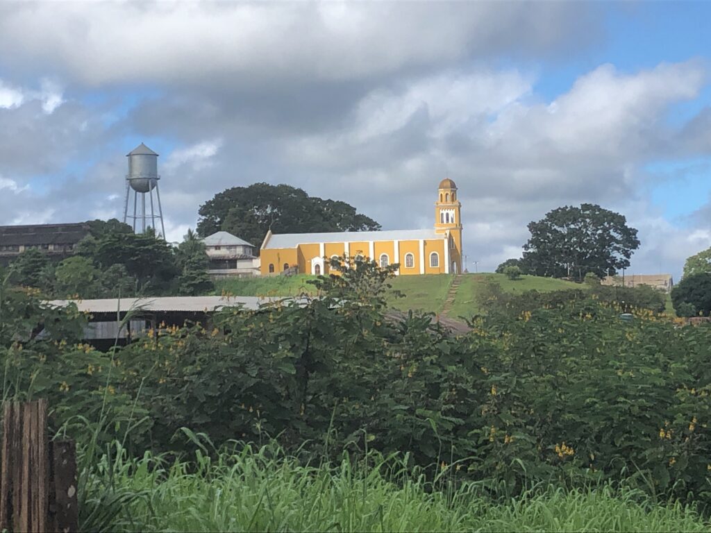 ellow church with water tower in Fordlândia, Brazil